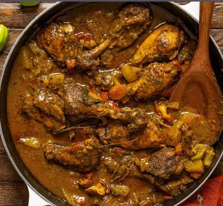 Delicious plate of authentic Jamaican Curry Chicken served with rice and peas