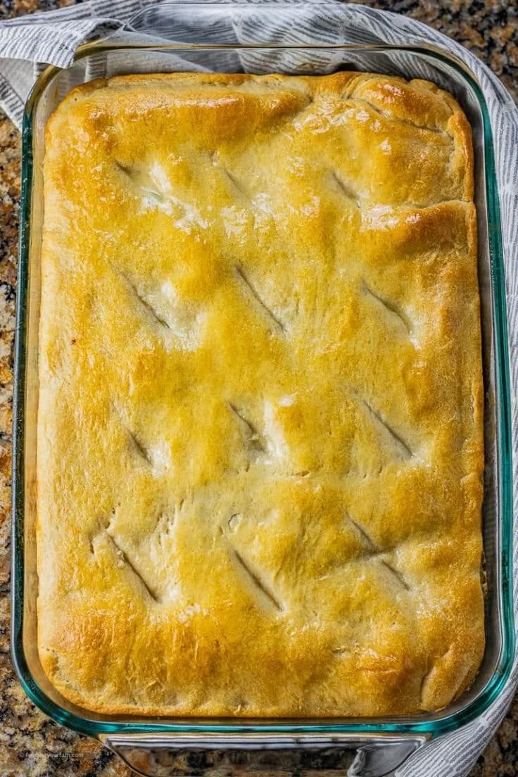 Delicious chicken pot pie made with crescent rolls, served in a rustic dish.