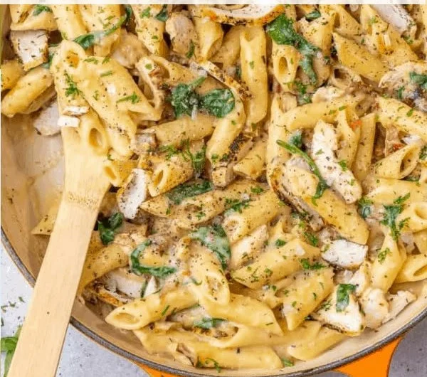 Creamy Chicken Spinach Pasta garnished with parmesan cheese