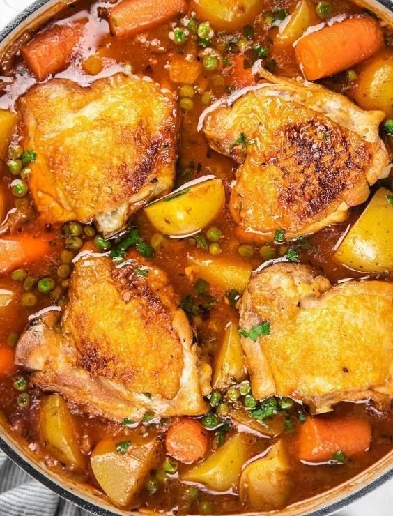 Delicious chicken stew in a bowl with vegetables and herbs