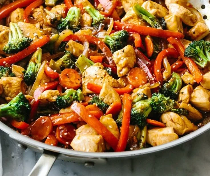 Colorful chicken stir-fry with vegetables in a pan
