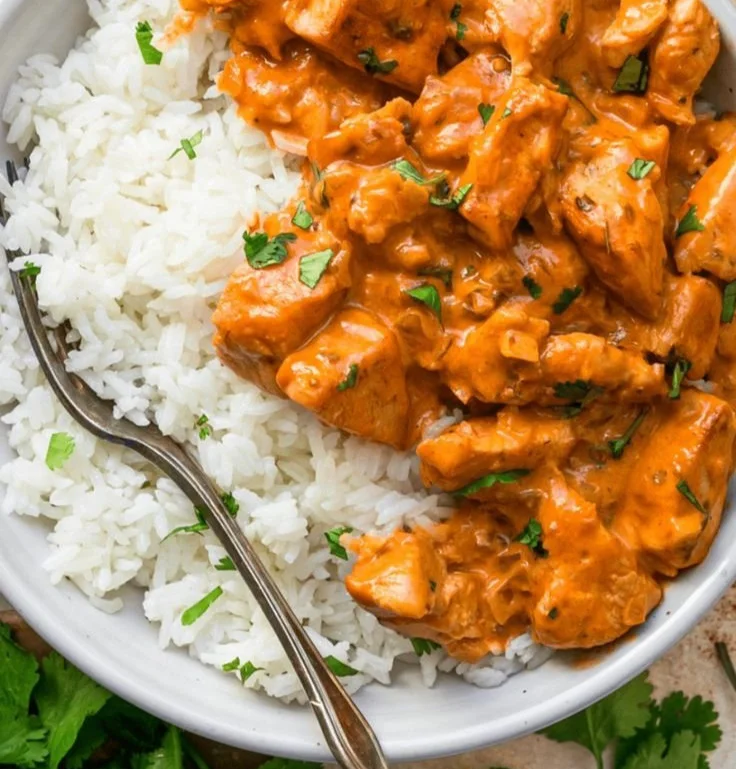 Coconut Chicken Rice Bowl topped with fresh herbs and served in a vibrant dish