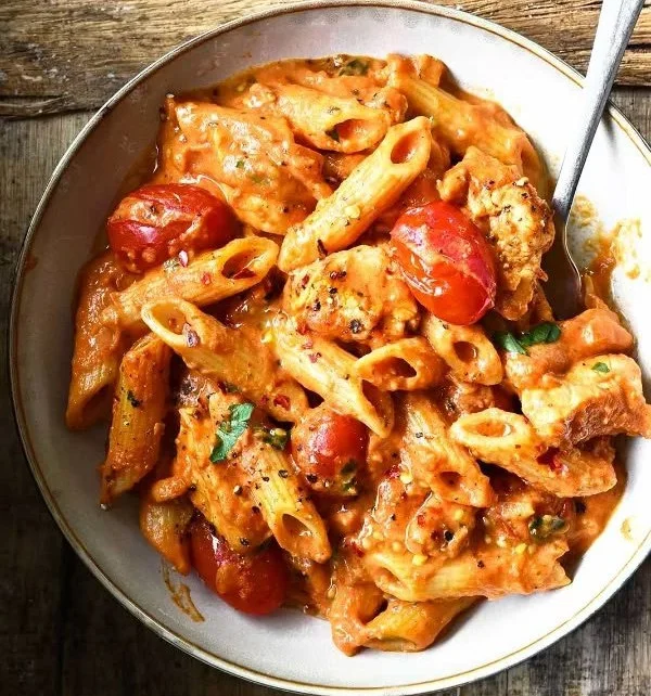 Creamy Chicken all'Arrabbiata served on a plate with fresh herbs and chili peppers
