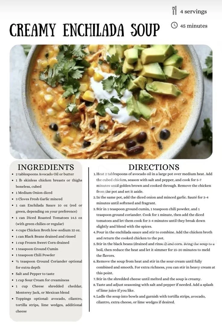 Bowl of creamy enchilada soup garnished with cilantro and lime wedges