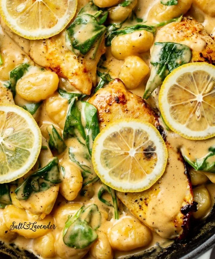 Creamy lemon chicken gnocchi dish served on a plate, garnished with fresh herbs.