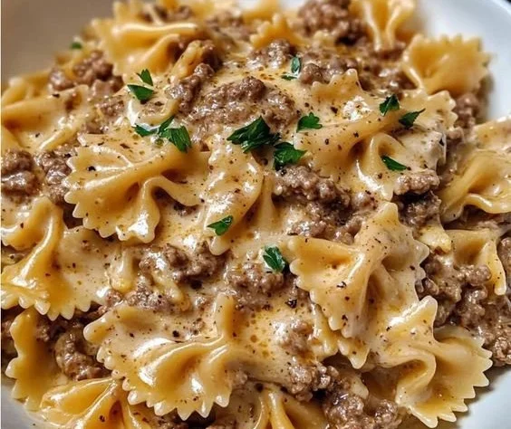 Creamy Parmesan Garlic Beef Bowtie Pasta served with herbs
