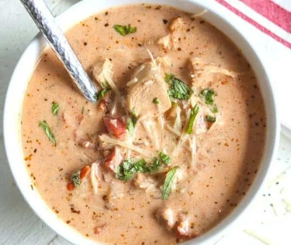 Creamy sun-dried tomato chicken soup in a bowl