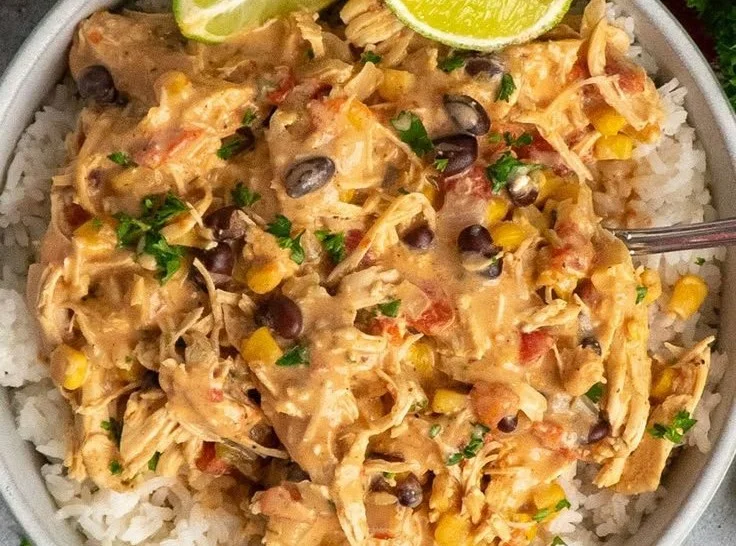 Crock Pot Fiesta Chicken served in a bowl with fresh toppings