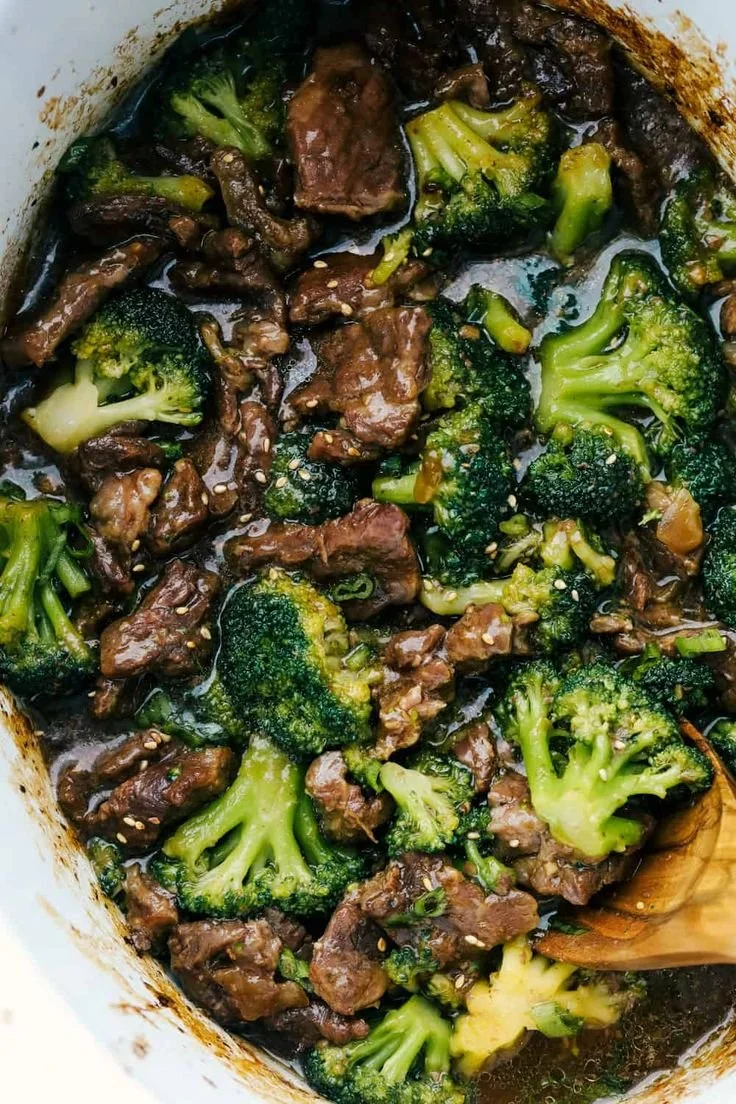 Slow cooker beef and broccoli served in a bowl with rice