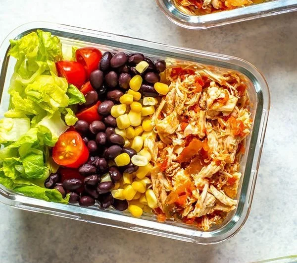 Crockpot salsa chicken dish garnished with fresh ingredients