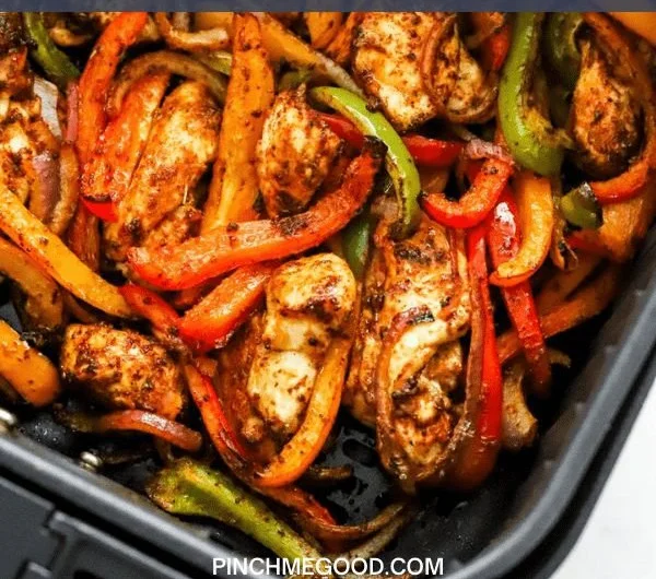 Easy air fryer chicken fajitas served with peppers and onions