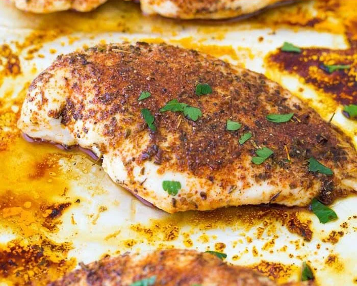 Juicy and flavorful easy baked chicken breasts served on a plate