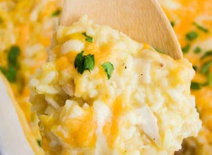 Easy chicken and rice casserole served in a baking dish with herbs and cheese