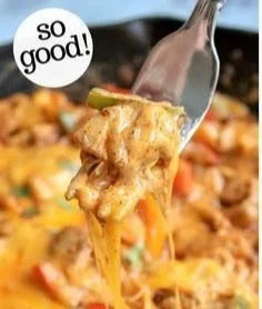 Easy chicken fajita casserole garnished with cheese and peppers in a baking dish