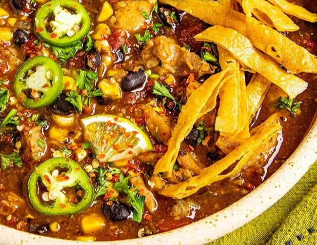 Bowl of easy chicken tortilla soup with toppings