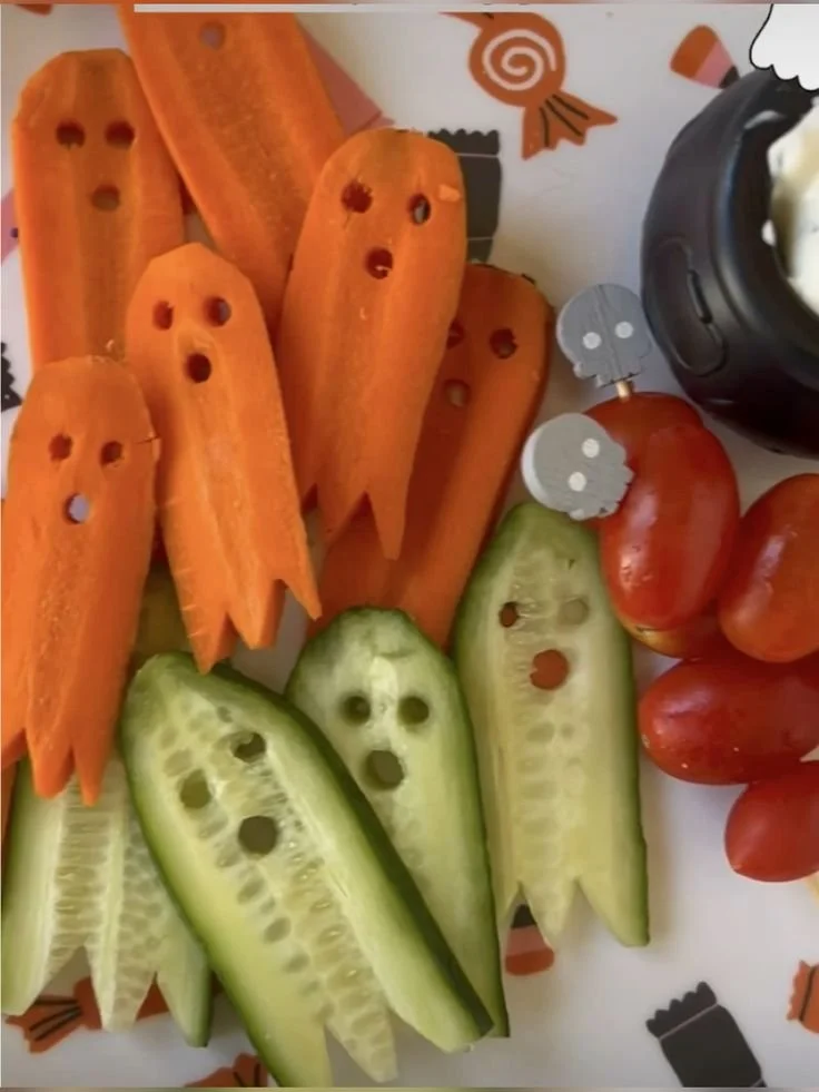 Colorful Halloween dishes featuring healthy food ideas for kids' parties.