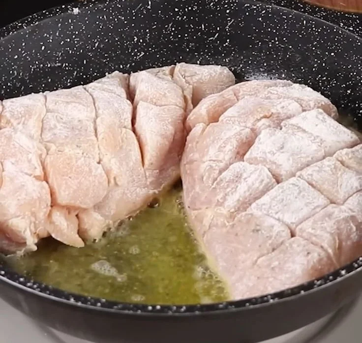 Delicious Garlic Butter Chicken served with herbs and lemon on a plate.