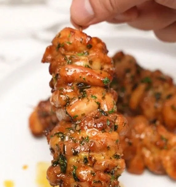 Plate of juicy Garlic Herb Chicken Skewers garnished with fresh herbs