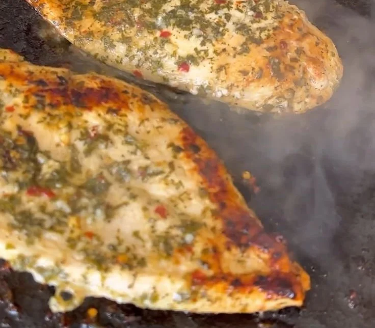 Delicious Greek chicken dish garnished with herbs and lemon