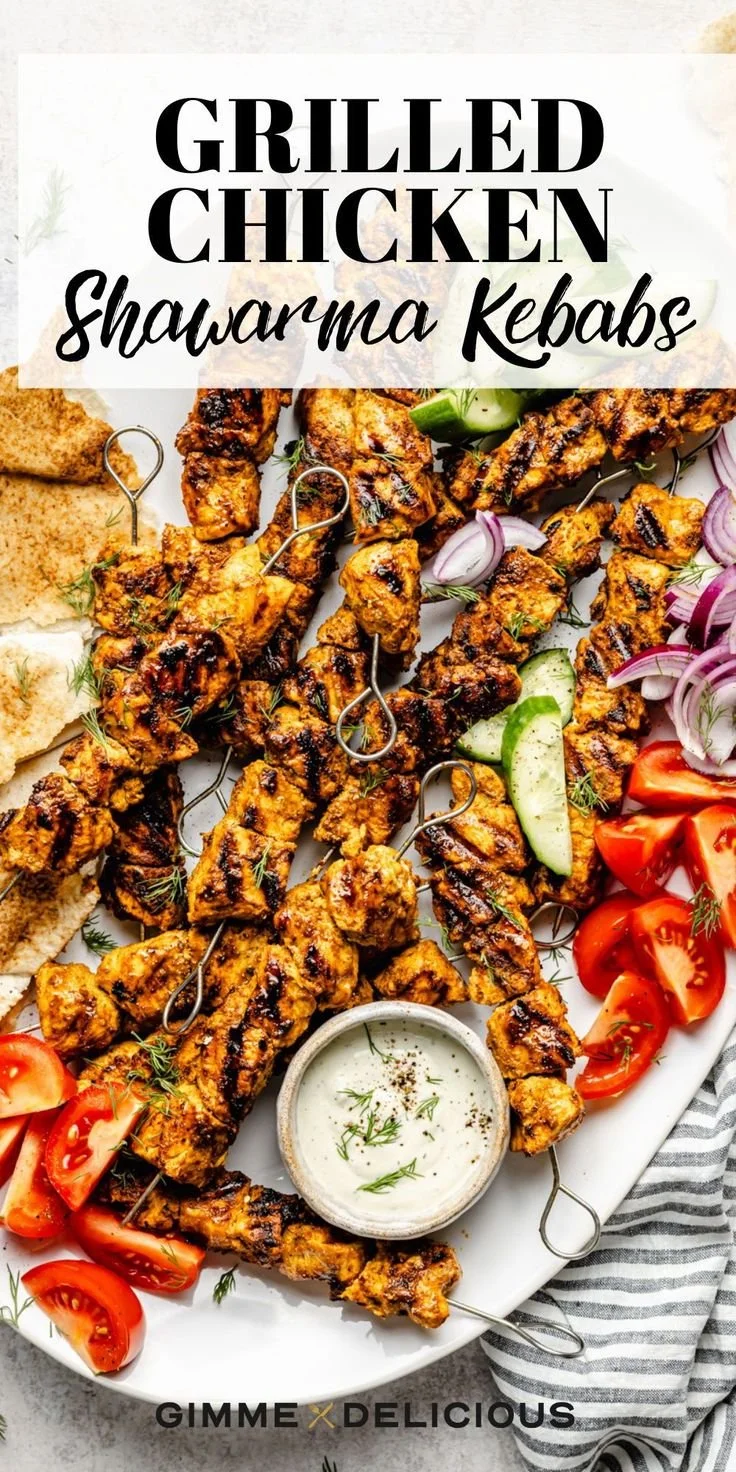 Grilled chicken shawarma kebabs served with fresh vegetables and sauces