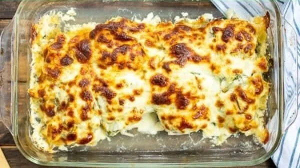 Healthy spinach artichoke chicken bake served in a vibrant dish.