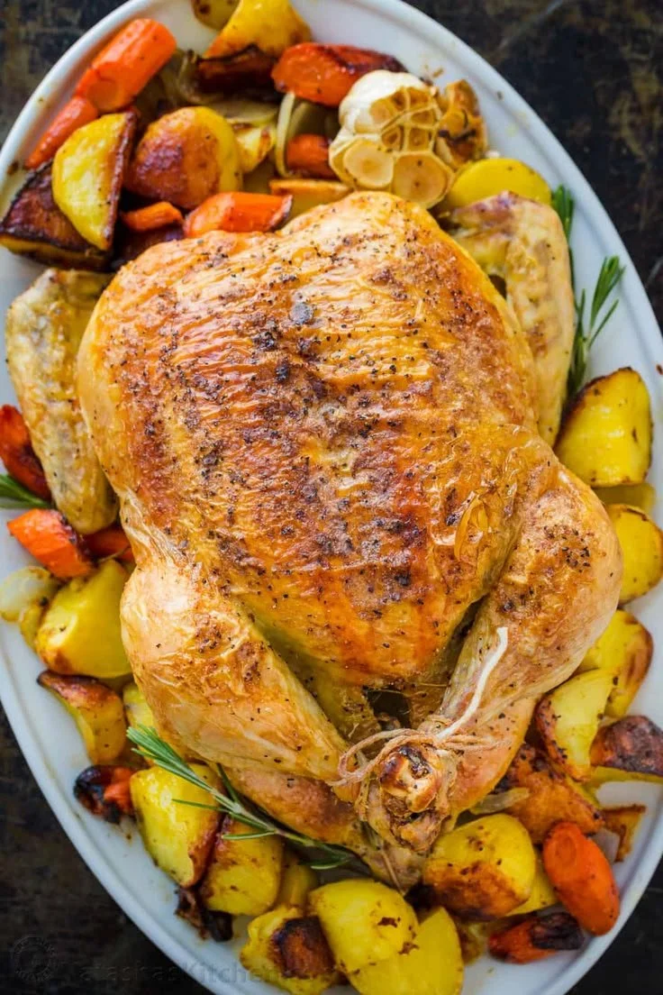 Juicy roast chicken with colorful vegetables roasted to perfection.