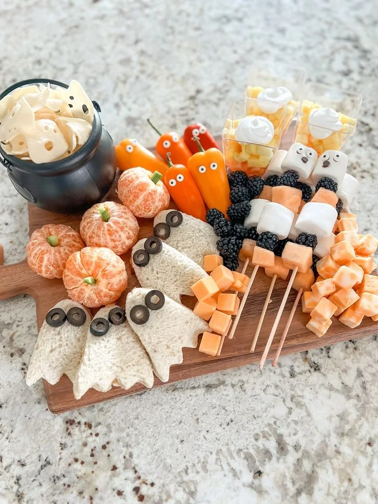 Kid's Halloween CharCUTErie Board filled with festive treats and decorations.