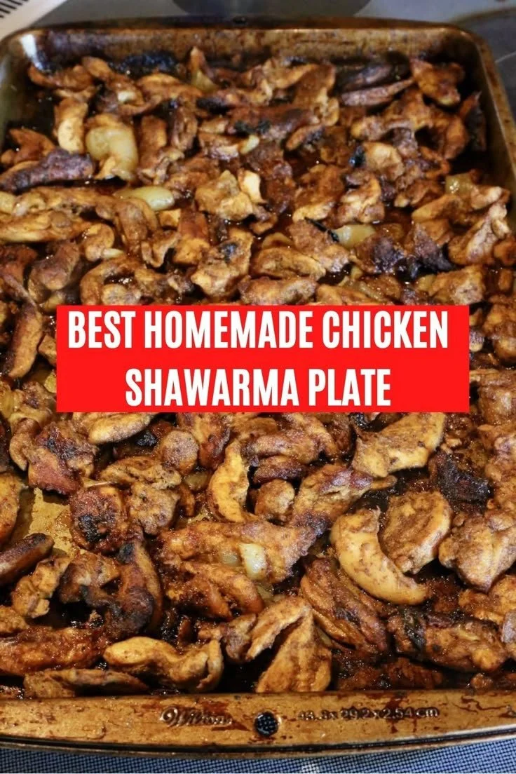 Healthy Lebanese Chicken Shawarma on a sheet pan, garnished with vegetables.