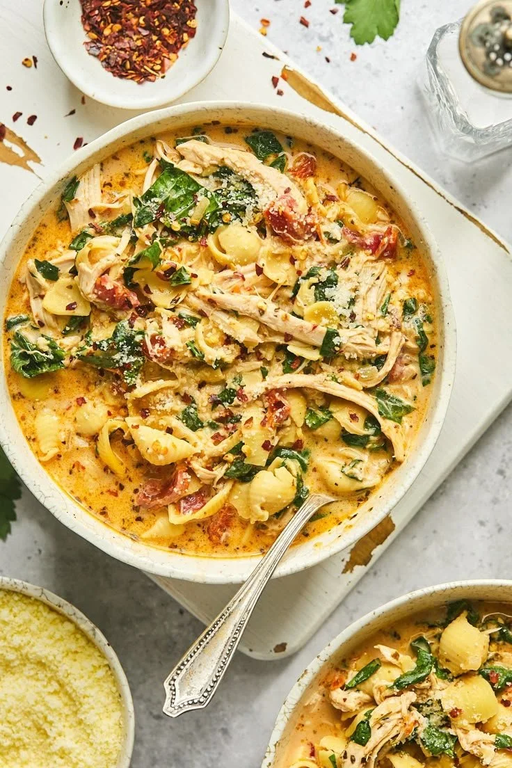 Bowl of gluten-free Marry Me Chicken Soup garnished with herbs.