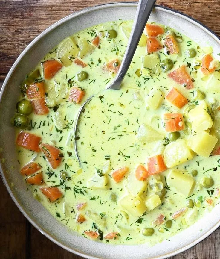 Bowl of Polish Dill Soup with fresh dill and potatoes