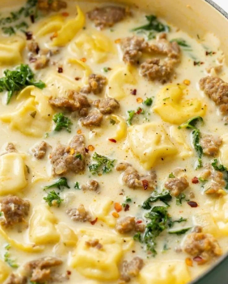Bowl of Sausage Tortellini Soup with fresh herbs and ingredients