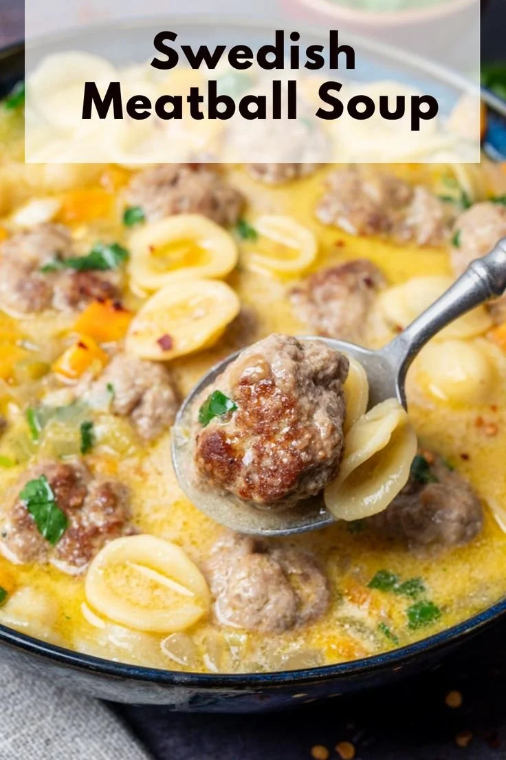 Bowl of simple Swedish meatball soup with fresh herbs and meatballs