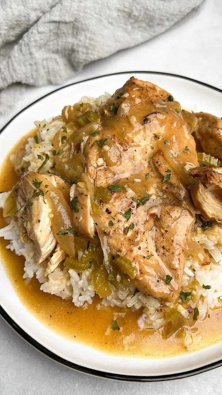 Slow cooker smothered chicken served with gravy and vegetables