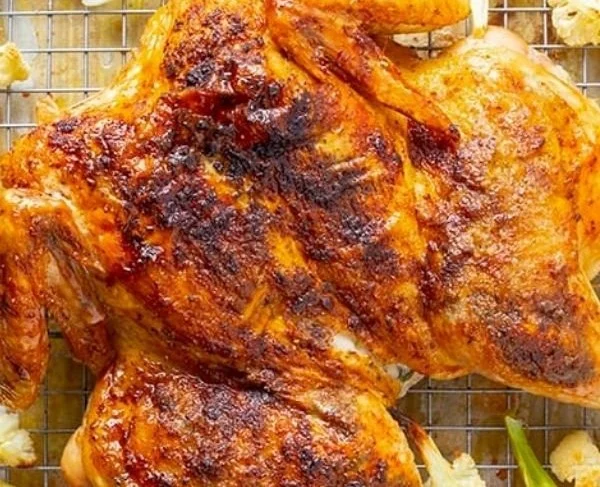 Spatchcock roast chicken served with herbs and spices for a delicious meal