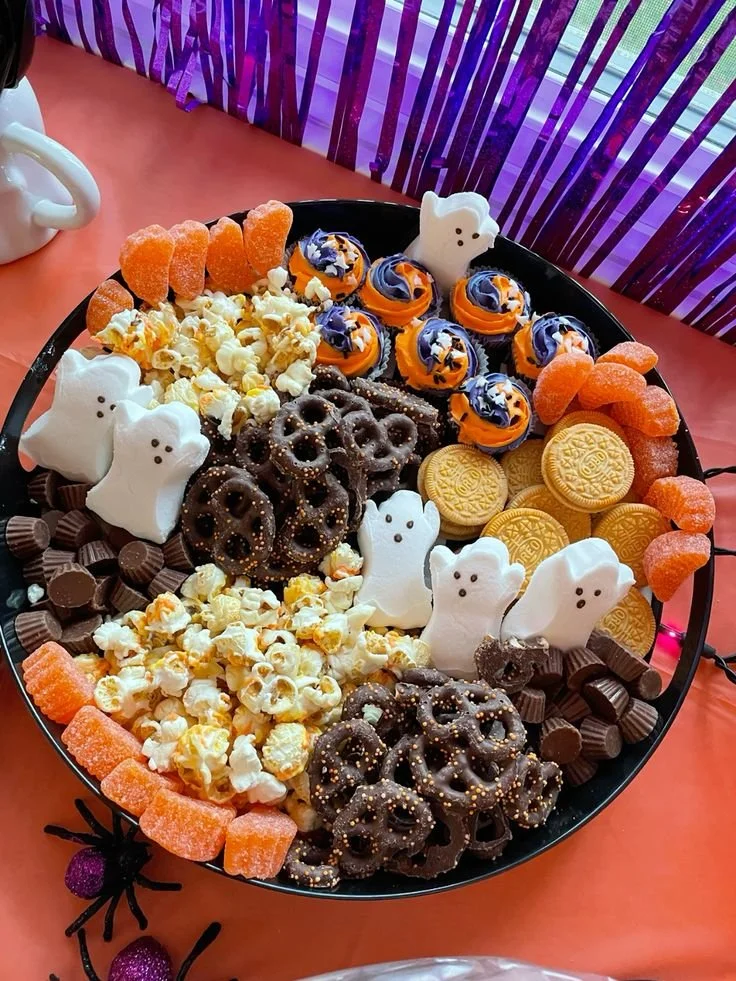 A spooky charcuterie board with Halloween-themed cheeses and treats.