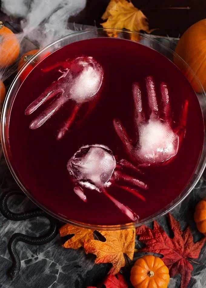 Spooky Halloween Party Punch in a decorative bowl with creepy garnish.
