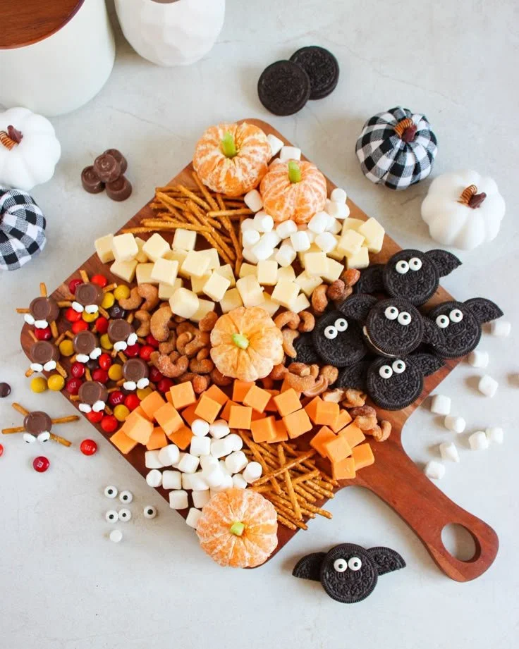 Colorful Halloween charcuterie board with spooky theme items.