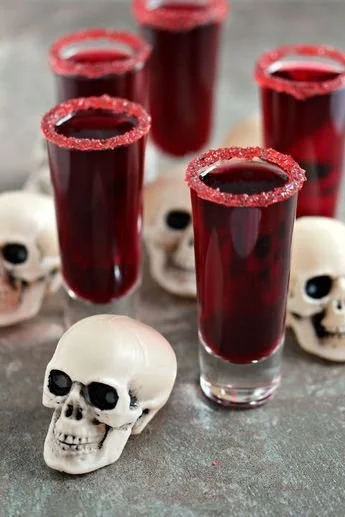 Festive Halloween cocktails with red drinks for a spooky celebration after college.
