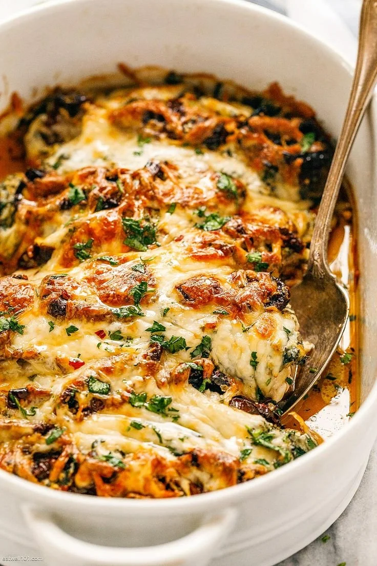 Baked Tuscan Chicken Casserole in a serving dish, garnished with herbs
