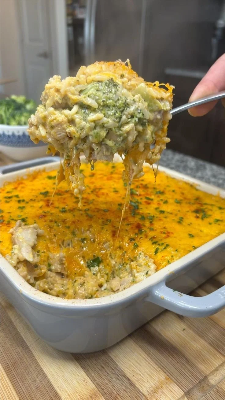 Bowl of creamy broccoli cheese casserole topped with golden cheese