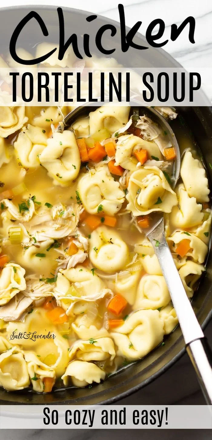 Bowl of chicken tortellini soup garnished with herbs