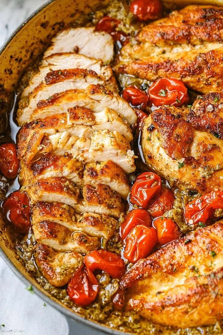 Creamy pesto chicken with roasted tomatoes served in a bowl