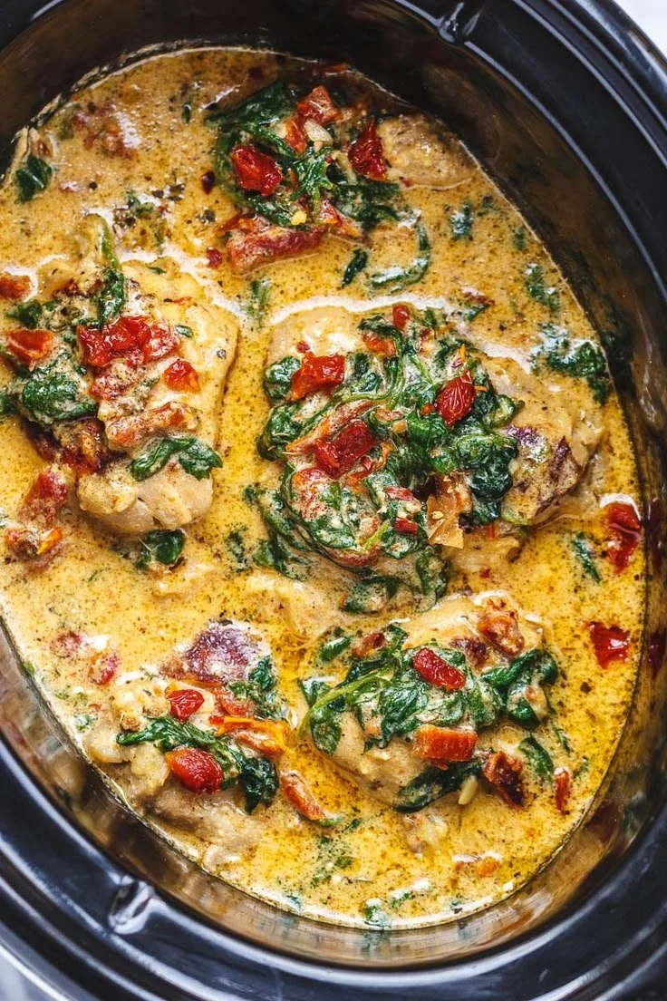 CrockPot Tuscan Garlic Chicken in a slow cooker with fresh herbs