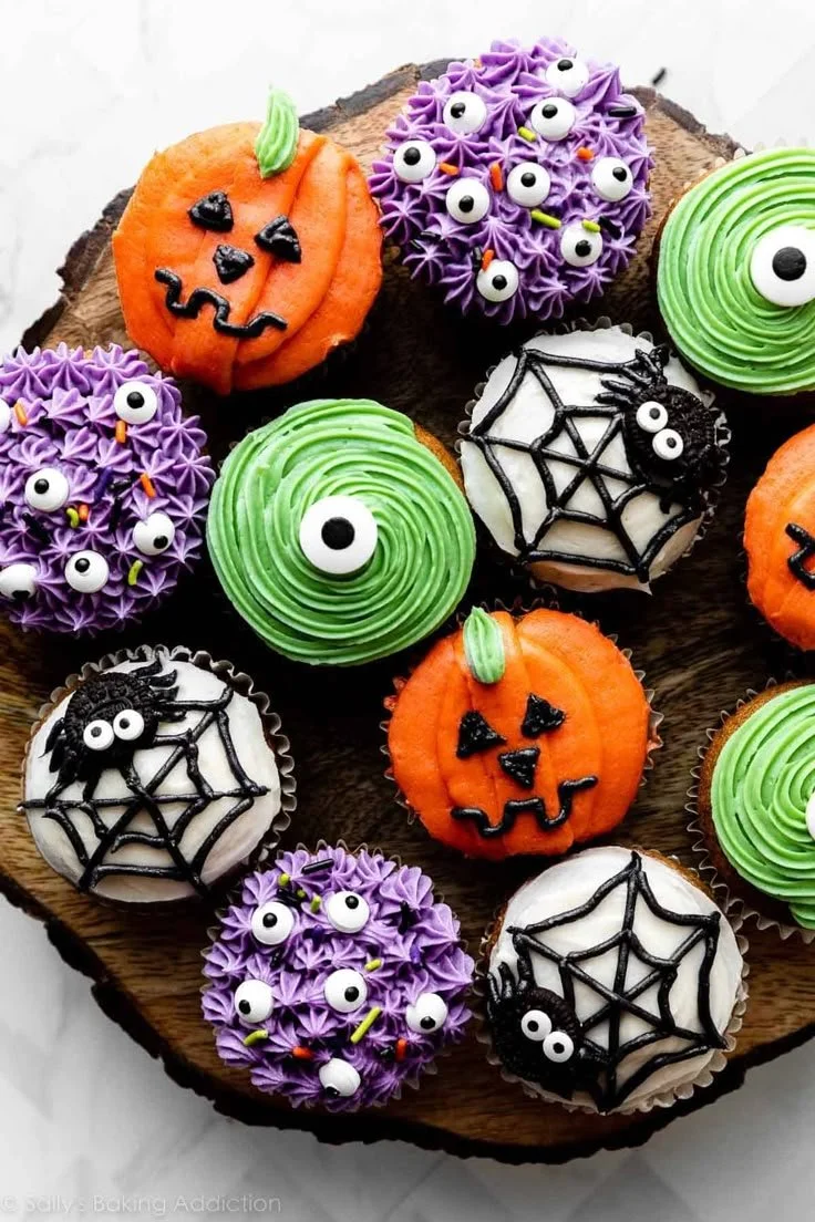 Colorful decorated Halloween cupcakes with spooky designs for festive celebrations.
