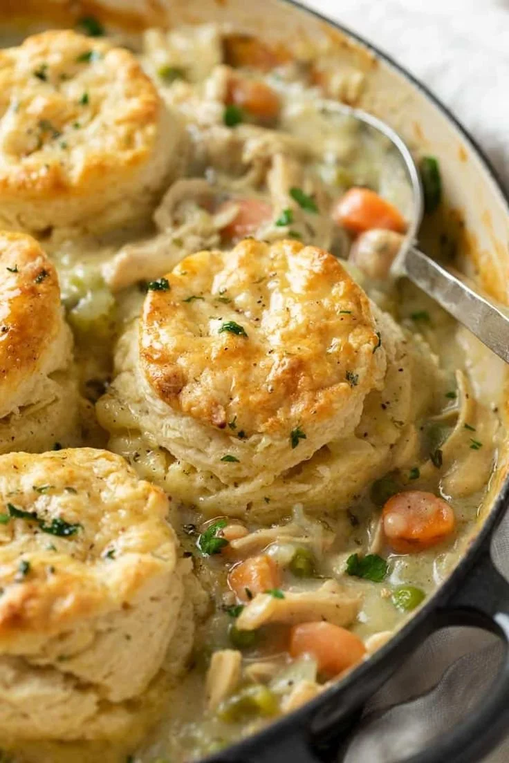Easy and delicious chicken pot pie with biscuits served in a rustic dish