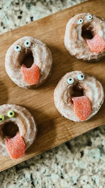Halloween spooky snacks including a donut wreath and decorated donuts