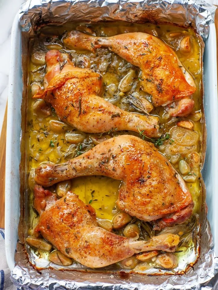 Oven-roasted French garlic chicken served on a plate garnished with herbs