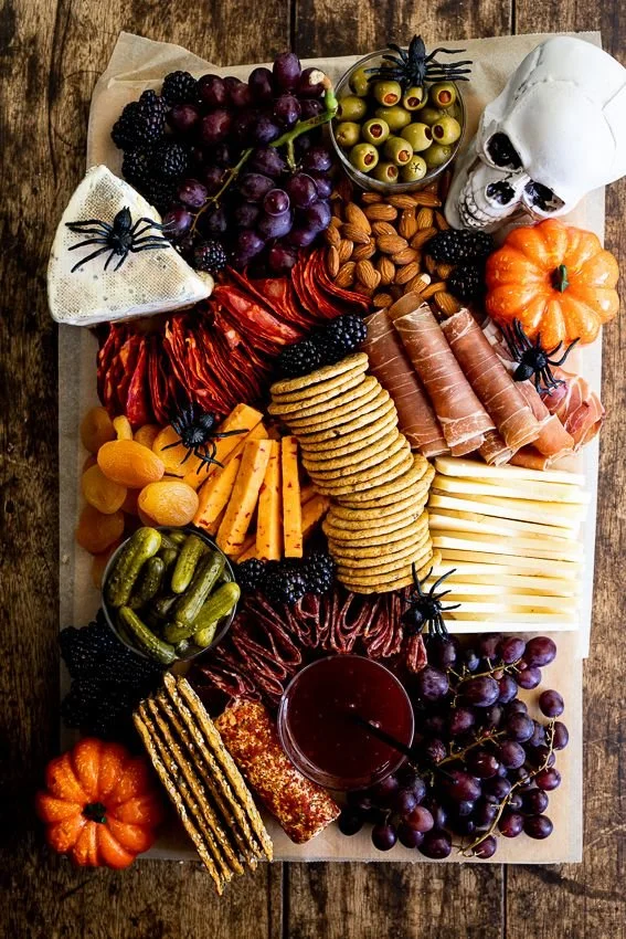 Colorful Halloween charcuterie board featuring spooky-themed snacks and treats.
