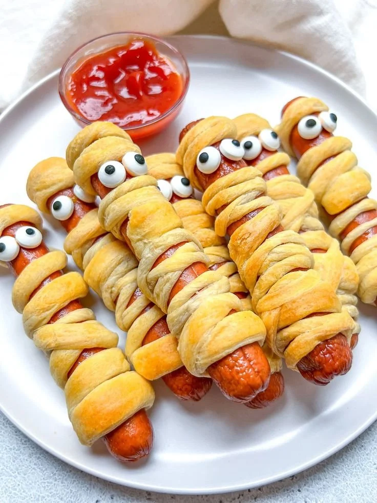 Halloween mummy hotdogs wrapped in dough, perfect for spooky celebrations