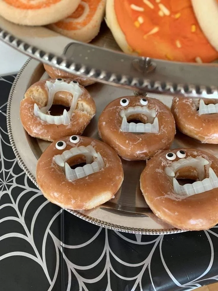 Spooky Halloween snacks and festive donuts for a kids' potluck.
